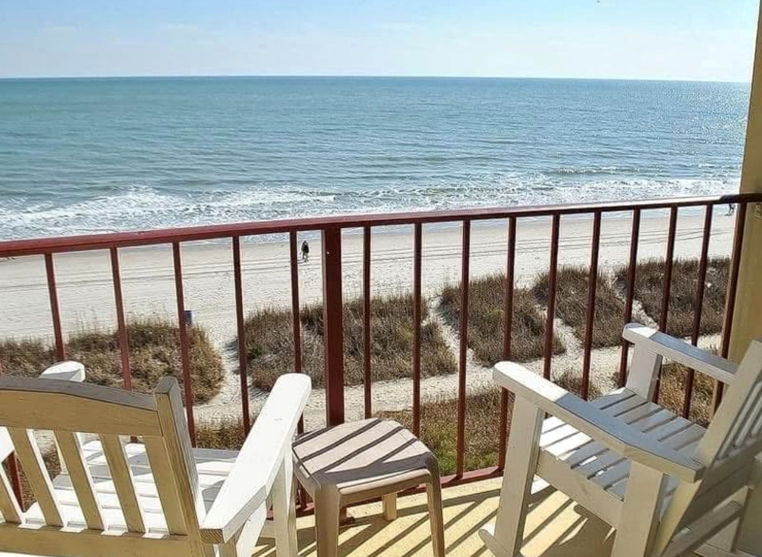 Private balcony with ocean view and white chairs